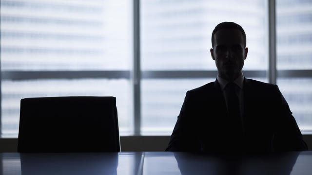 Silhouette of businessman in office meeting room 