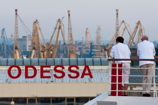 Passengers of a cruise ship look out at the port of Odessa, Ukraine 