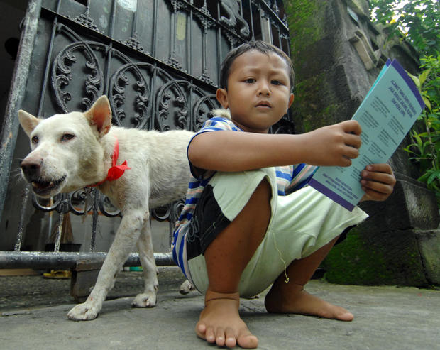 A child holds his dog's certificate afte 