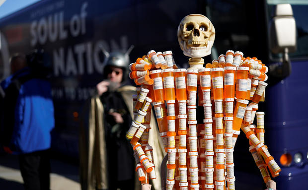 A sculpture made out of opioid pill bottles is set up next to Democratic presidential candidate and former Vice President Joe Biden's campaign bus in Somersworth 