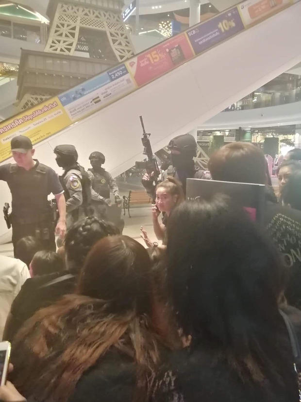 People are evacuated from a shopping mall by members of security forces after a shooting rampage in the city of Nakhon Ratchasima 