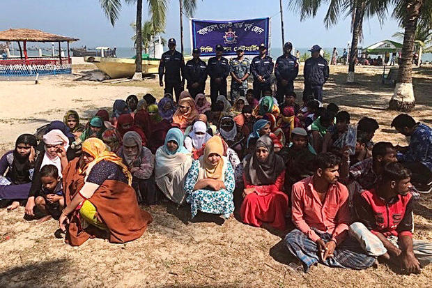 Rohingya refugees wait after their boat capsized near the Saint Martin's island in the Bay of Bengal, in Teknaf, near Cox's Bazar 
