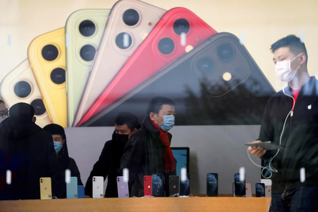 People wearing protective masks are seen in an Apple Store in Shanghai, China, January 29, 2020. 