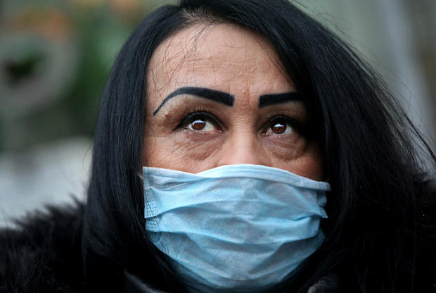 A woman wearing a face mask poses for a picture in New York City's Chinatown February 13, 2020. 