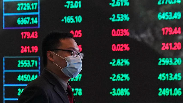 A man wearing a protective mask is seen inside the Shanghai Stock Exchange building, as the country is hit by a new coronavirus outbreak, at the Pudong financial district in Shanghai 