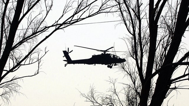 A US army Black Hawk helicopter flies ov 