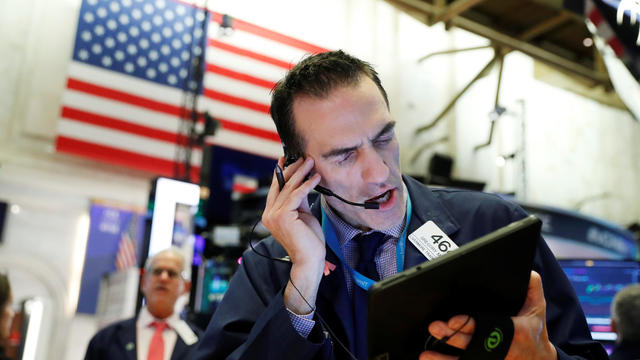 Traders work on the floor of the New York Stock Exchange shortly after the closing bell in New York 