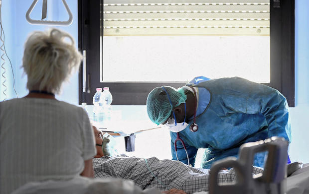 Medical worker wearing a protective mask, glasses and suit treats a patient suffering from coronavirus disease (COVID-19) in an intensive care unit at the Oglio Po hospital in Cremona 