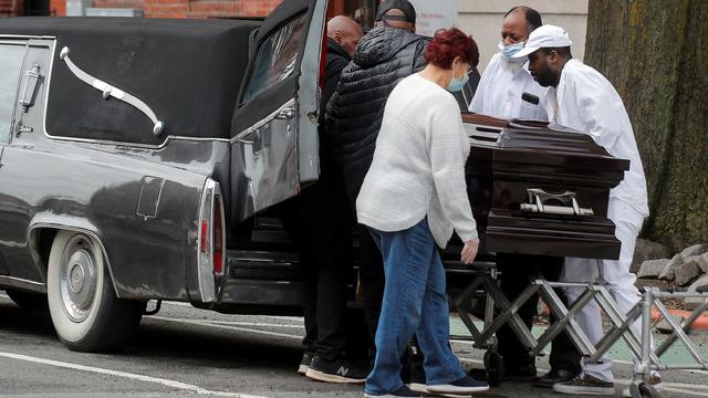 Pallbearer and staff place the body of a deceased family member during a funeral at Jurek-Park Slope Funeral Home during the outbreak of the coronavirus disease (COVID19) in Brooklyn, New York 