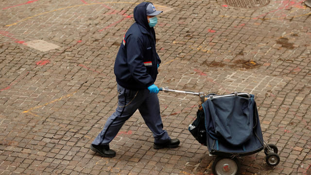 A United States Postal Service worker wears a mask to prevent exposure to the coronavirus disease (COVID-19) in New York 