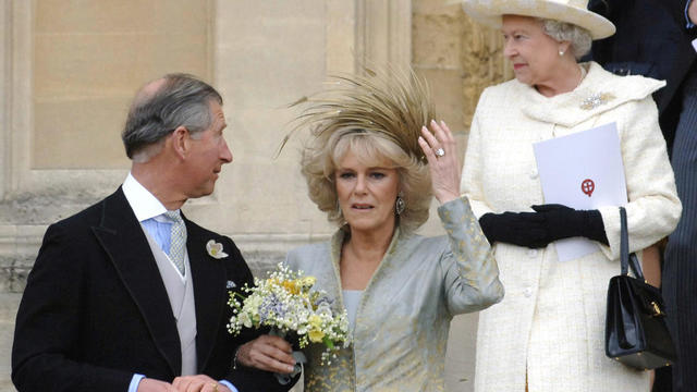 Britain's Prince Charles (L) looks at hi 