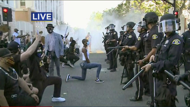Protester Kneels in Front of Police Line in Downtown San Jose 