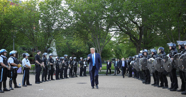 President Trump walks between lines of riot police in Washington, D.C. 