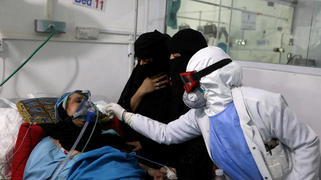 FILE PHOTO: Women watch as a nurse attends to their relative who is being treated at an intensive care unit of a hospital for the coronavirus disease (COVID-19) in Sanaa 