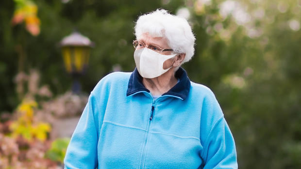 Senior lady with a walker in face mask 
