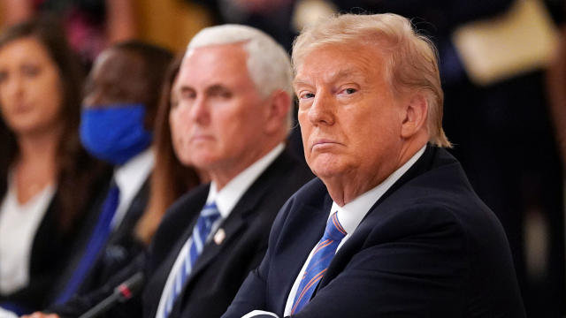 President Trump is seated next to Vice President Mike Pence as he listens during an event on reopening schools amid the coronavirus pandemic in the East Room at the White House in Washington July 7, 2020. 