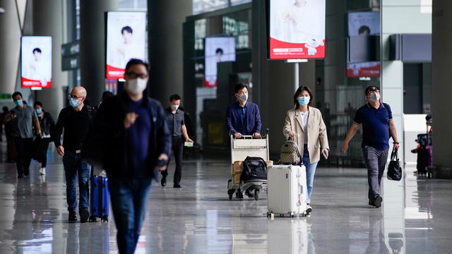 FILE PHOTO: People wearing face masks are seen at Hongqiao International Airport in Shanghai 