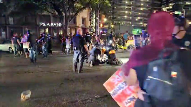 Police and protesters gather around a demonstrator who got shot during a Black Lives Matter protest in downtown Austin, Texas 