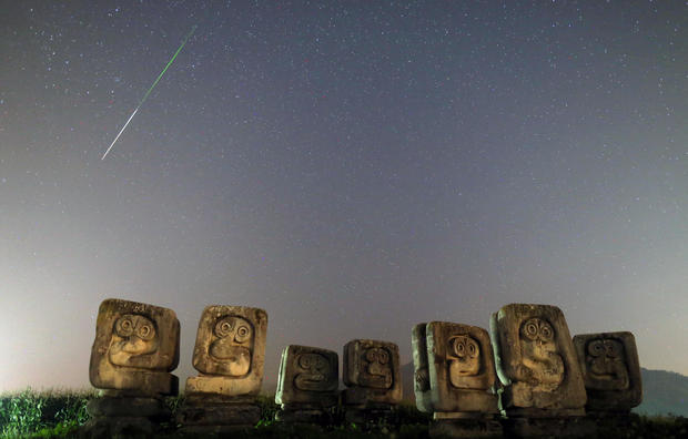 A meteor streaks past stars in the night sky above the Necropolis on Smrike for the victims of Fascism during the Perseid meteor shower in Novi Travnik 