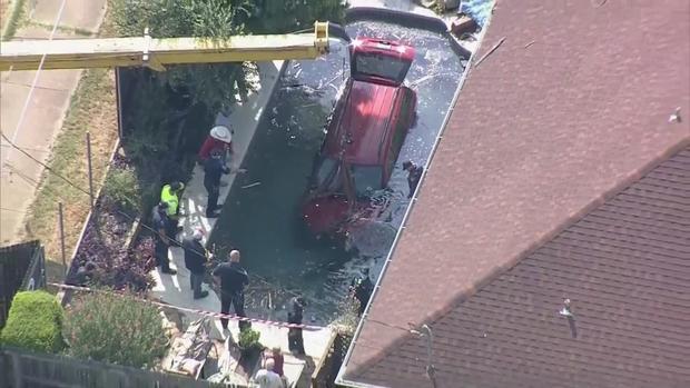 Vehicle in backyard pool in Arlington 