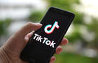 In this photo illustration a TikTok logo displayed on a 