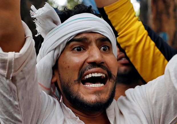 A demonstrator shouts slogans during a protest after the death of a rape victim, in New Delhi 