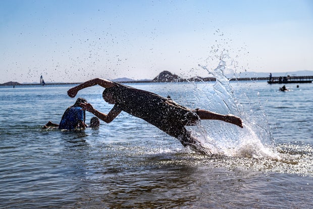 People cooling off in the lake at Lake Perris State Recreation Area in Perris, CA