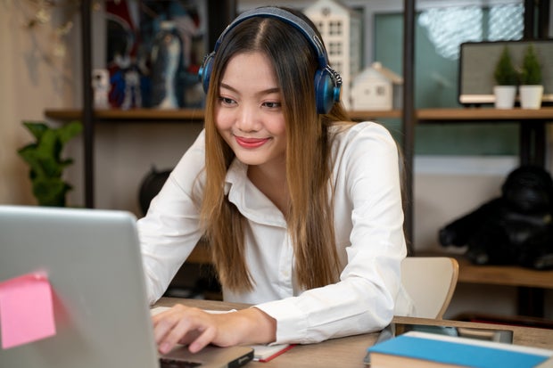 remote learning laptop school student Teenage girl with headphones having online school class at home 