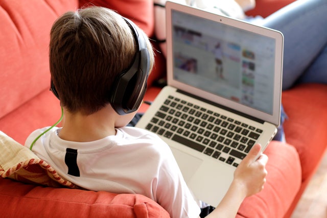 remote learning laptop school student Boy Playing Video Game On Computer 