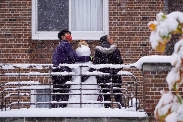 U of M Students make snowman during October snow storm 