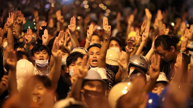 People show the three-fingered salute during a protest, in Bangkok 
