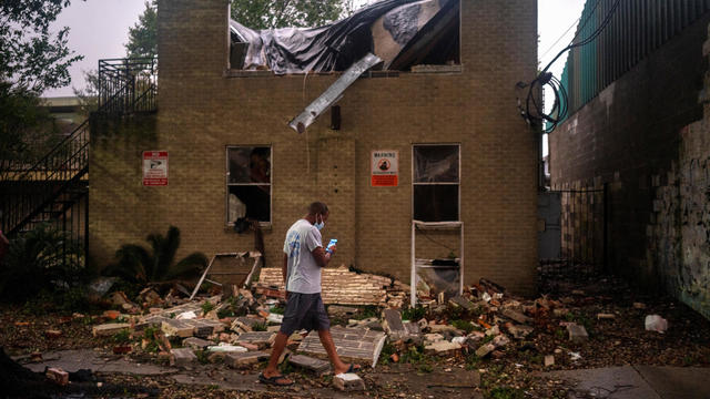 Joel Martinez, who until just recently lived in the lower apartment, makes a photo of Washington Gardens Apartments after it collapsed from the winds brought by Hurricane Zeta in New Orleans, Louisiana, on October 28, 2020. 