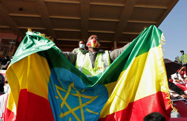 A volunteer holds an Ethiopian flag during a blood donation ceremony for the injured members of Ethiopia's National Defense Forces fighting against Tigray's special forces on the border between Amhara and Tigray, at the stadium in Addis Ababa, Ethiopia, N 