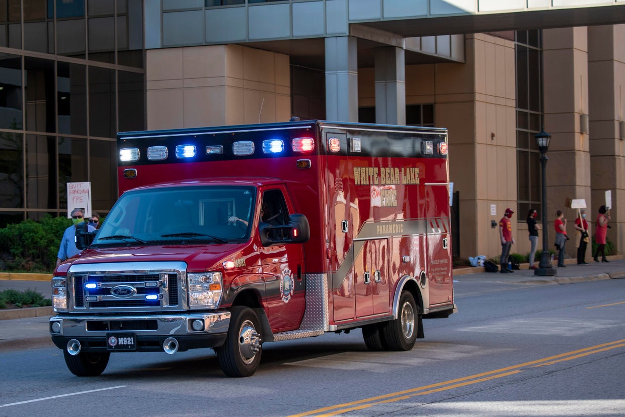 An ambulance on its way to the ER passes the nurses who are protesting the lack of masks and scrubs during the pandemic. They are demanding equipment, training, staffing and transpaency from United hospital and other hospitals. 