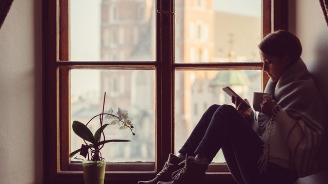 Woman on the window texting 