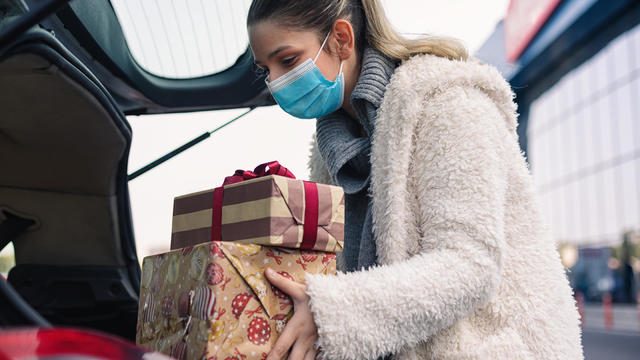 Teenage girl wears a protective mask while shopping for Christmas during COVID-19 pandemic 