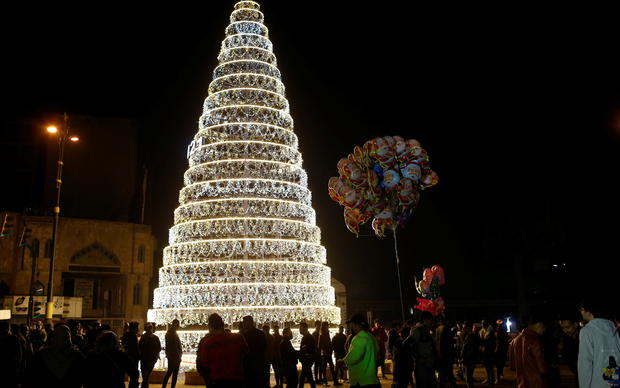 People gather at Tahrir square before the New Year celebrations in Baghdad 