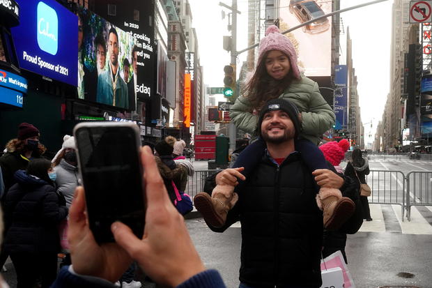 People take a photo in Times Square ahead of New Year's Eve 