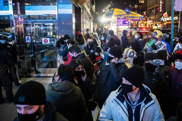 People wearing protective mask look for the Times Square ball near Times Square during the virtual New Year's Eve event following the outbreak of the coronavirus disease (COVID-19) in the Manhattan borough of New York City 