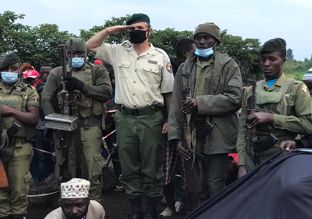 Virunga National Park Rangers and Park director Emmanuel Demerode salutes as they attend the burial of Burhani Abdou Surumwe in Goma 