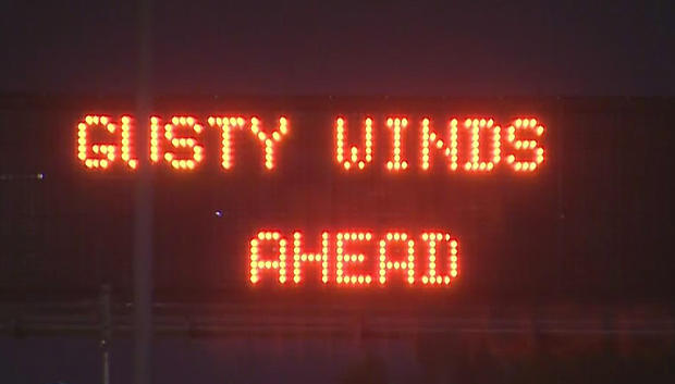 gusty winds ahead freeway sign 