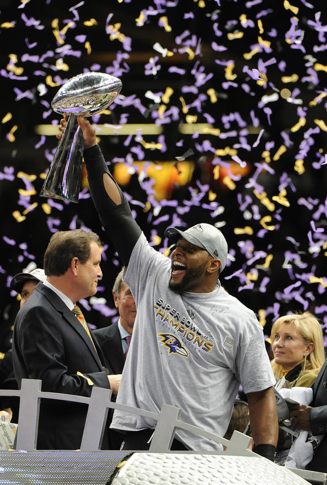 Baltimore Ravens linebacker Ray Lewis (L) watches teammate Ed Reed kiss the  Lombardi trophy at Super Bowl XLVII at the Mercedes-Benz Superdome on  February 3, 2013 in New Orleans. Baltimore beats San