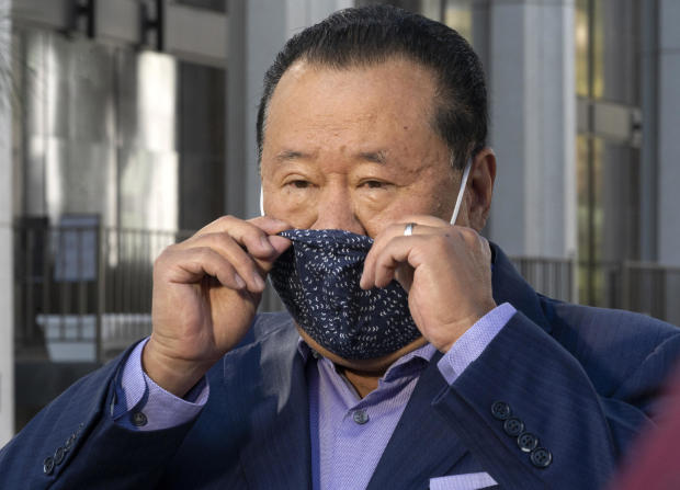Che Ahn, Harvest Rock's senior pastor, adjusts his face mask before a news conference outside the Harvest Rock Church in Pasadena, California, February 7, 2021. 