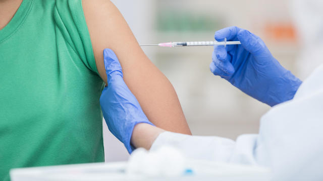 Unrecognizable girl receives flu shot 