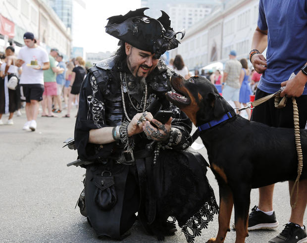 BOSTON, MA. - AUGUST 4: Ashton Synn, of Braintree, a pirate with Rogues' Armada, prepares to take a selfie with a dog named Zeus at the Boston Seafood Festival on August 4, 2019 in Boston, Massachusetts. (Photo By Mary Schwalm/MediaNews Group/Boston Heral 