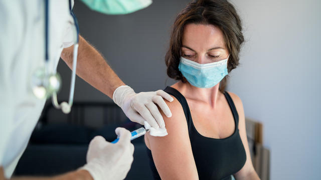 Woman with face mask getting vaccinated, coronavirus concept. 