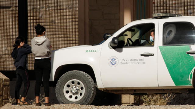 Migrants are detained by a U.S. Border Patrol agent as they turn themselves in to request asylum, after crossing into El Paso, Texas, U.S., as seen from Ciudad Juarez 