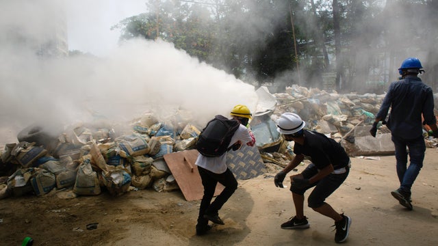 Protesters use fire extinguishers during a protest against the military coup in Yangon 