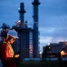 Petrochemical engineers work slowly and heavily with smart tablets in the oil and gas industry at night. 