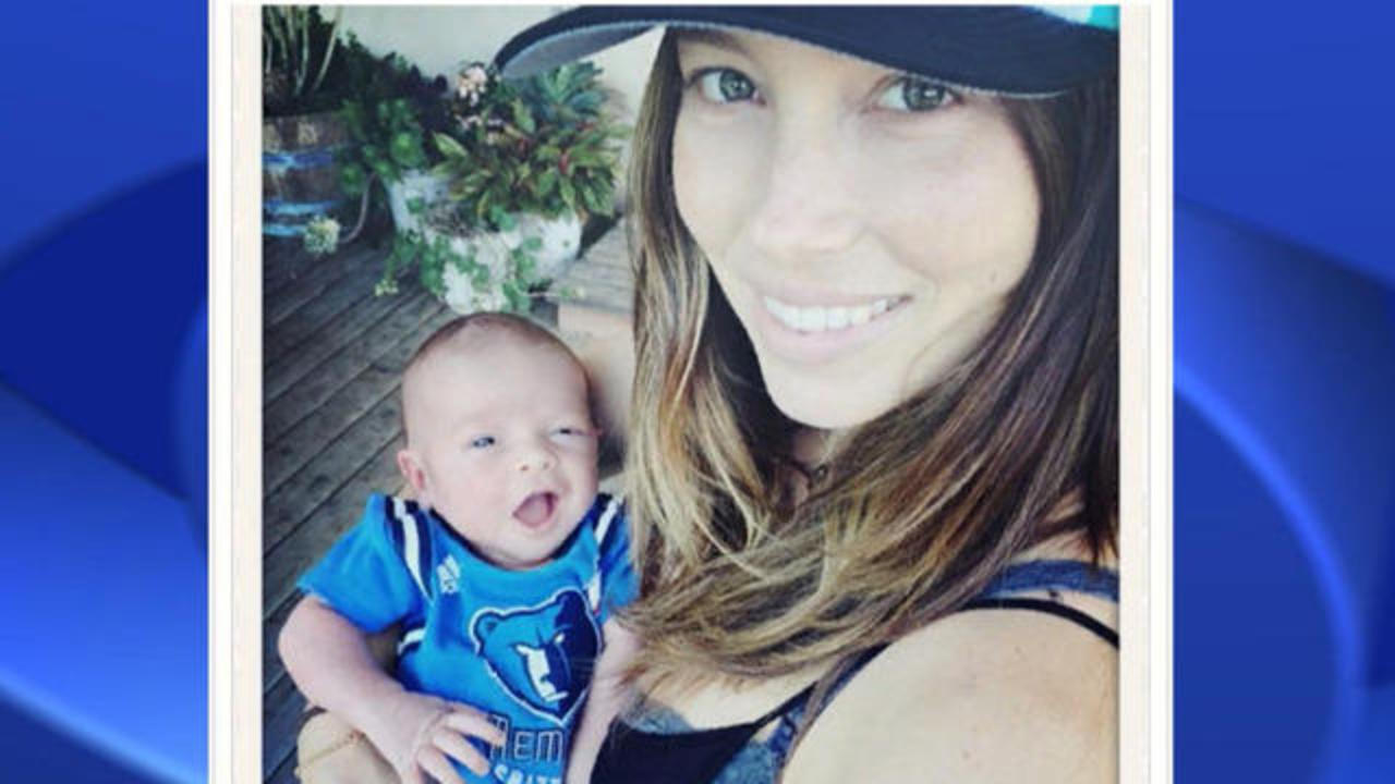 Justin Timberlake cradles son Silas as he and Jessica Biel board